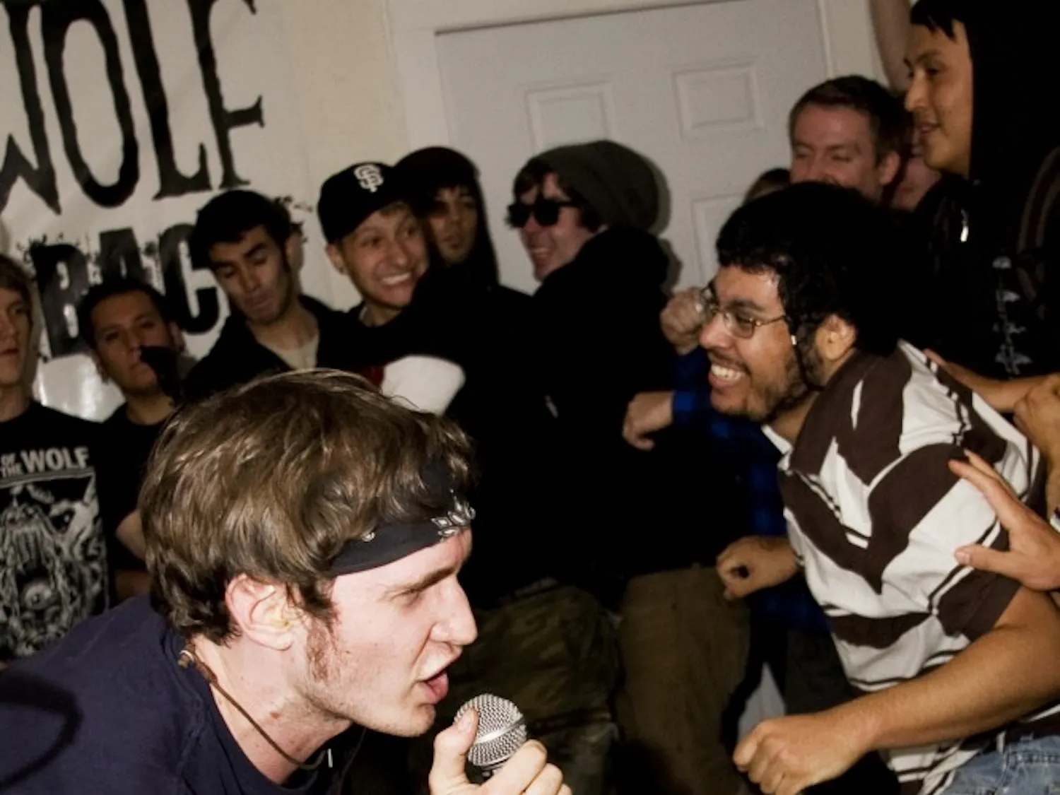 Kendal Fortson, lead singer for Stabbed In Back screams into the microphone, energizing moshing fans. The band is a melodic punk band from Albuquerque.