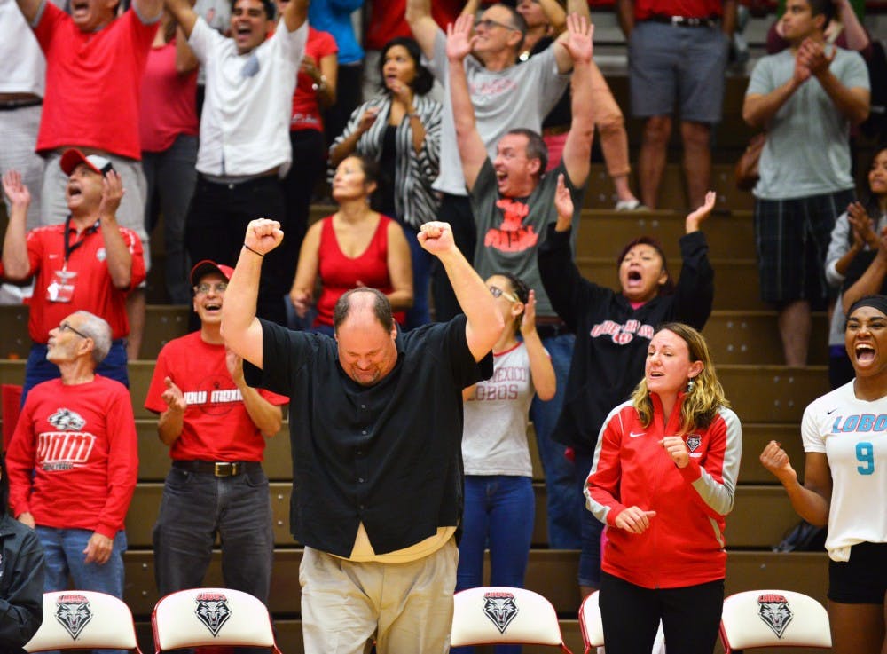 Head volleyball coach Jeff Nelson clinches his fists in the air as he wins his 400th career win. The Lobos achieved Nelson's 400th win with a 3-0 score against Santa Clara Friday night. 