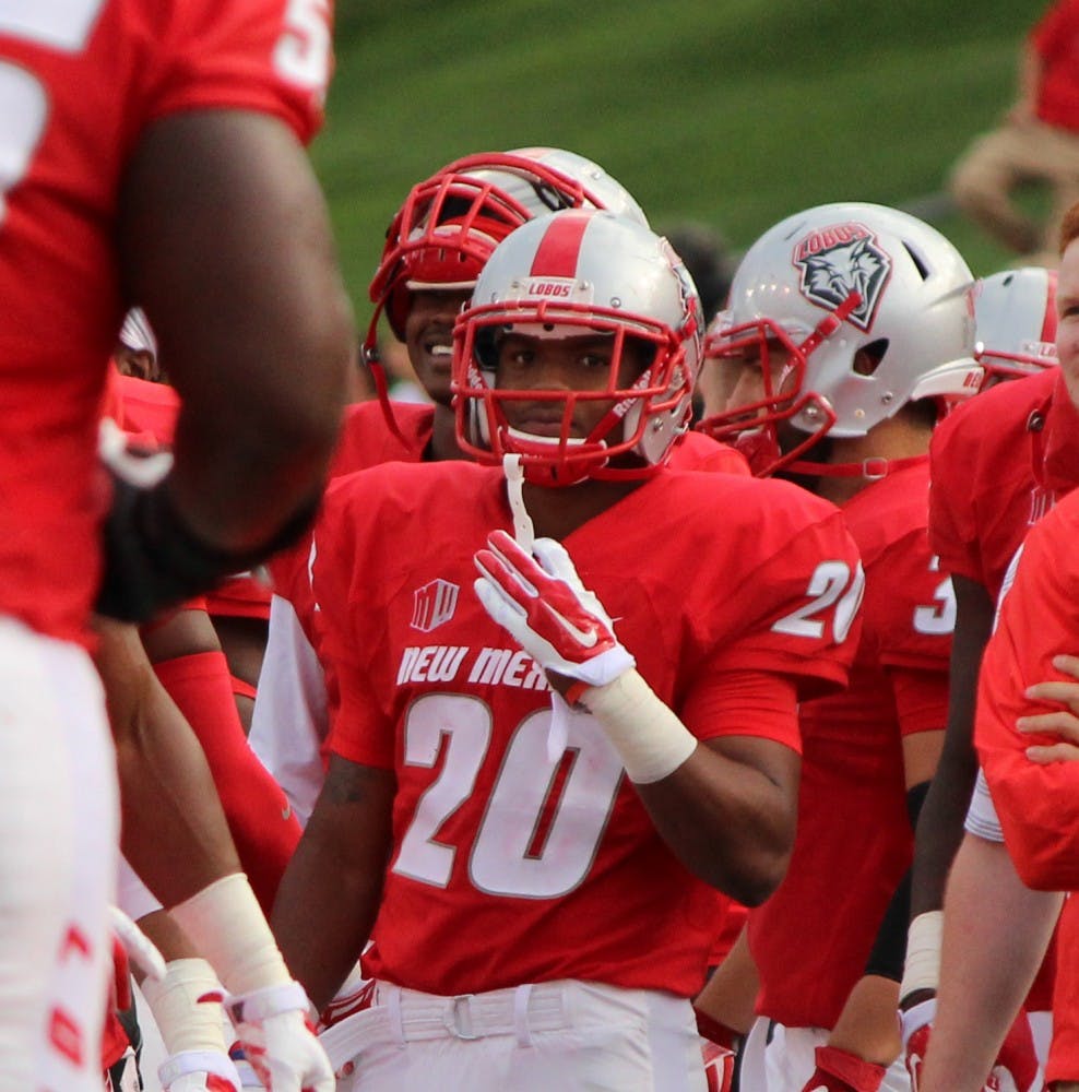 UNM sophomore running back Daryl Chestnut stands among his teammates during a media timeout on Friday night at University Stadium. Chestnut ran a 64 yard touchdown, helping the Lobos dominate 66-0 in the team’s season opener.
