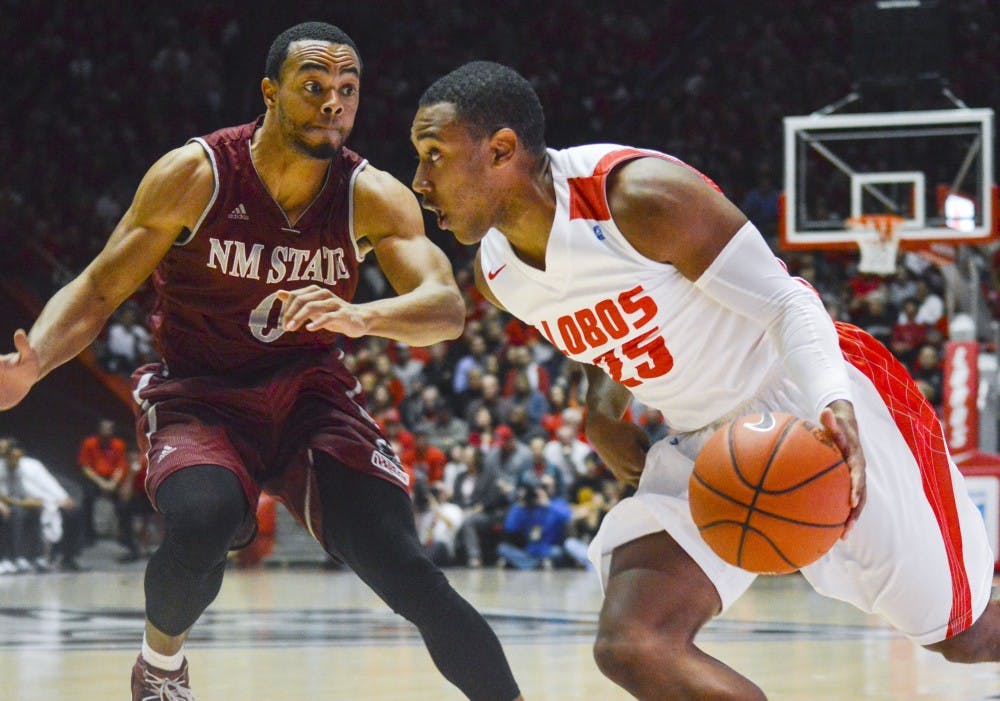 Lobo junior guard Tim Jacobs, 25, attempts to get past Aggie sophomore guard Travon Landry, 0, during the game against New Mexico State University at WisePies Arena on Wednesday night. The Lobos defeated the Aggies 62-47.