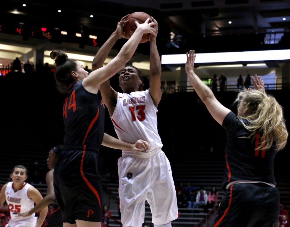 Senior forward Khadijah Shumpert leaps into the air against a Pepperdine player at WisePies Arena Dec. 12. The Lobos will play the Aggies this Sunday.&nbsp;