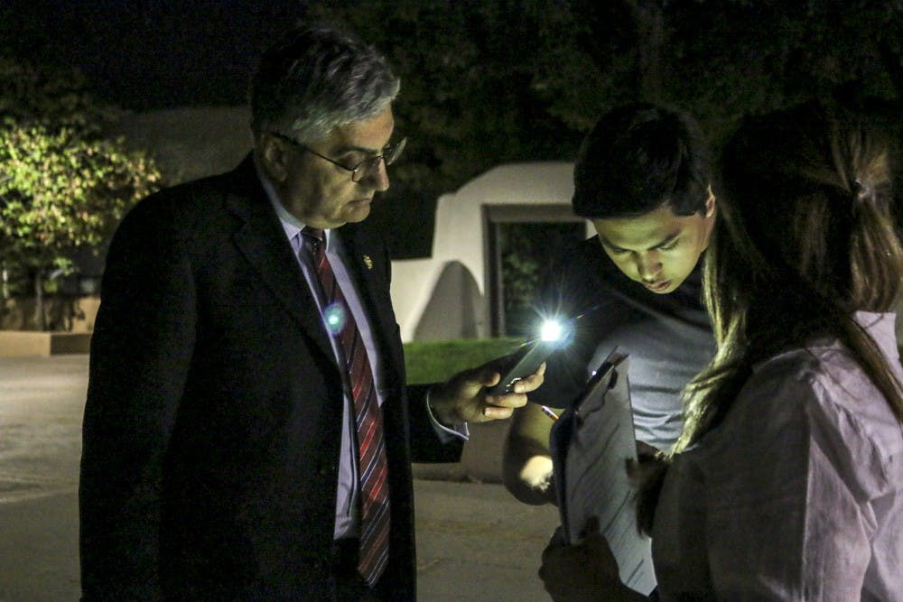 Left to right:&nbsp;UNM Interim President Chaouki Abdallah, Brendon Garcia and Shannon Figuera look for&nbsp;ways to improve campus safety using the&nbsp;sheet and map provided during the Campus Safety Walk on Sept. 19, 2017.&nbsp;