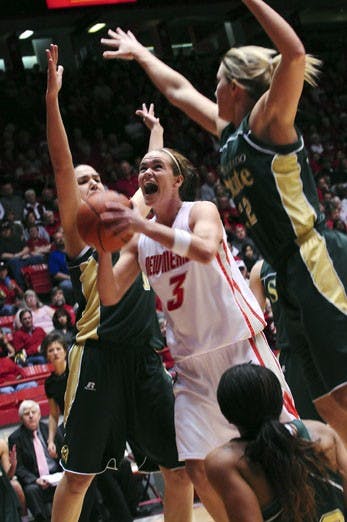 Eileen Weissmann splits two CSU defenders in Saturday's win over the Rams. The Lobos beat CSU 78-56 at The Pit.