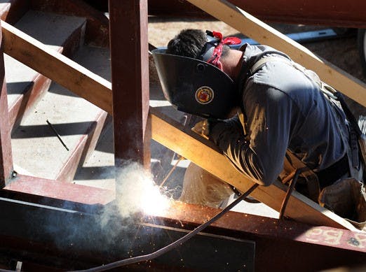 A construction worker welds on the UNM Biology Annex on Monday. 