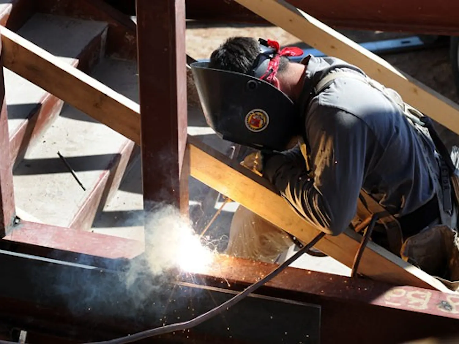A construction worker welds on the UNM Biology Annex on Monday.
