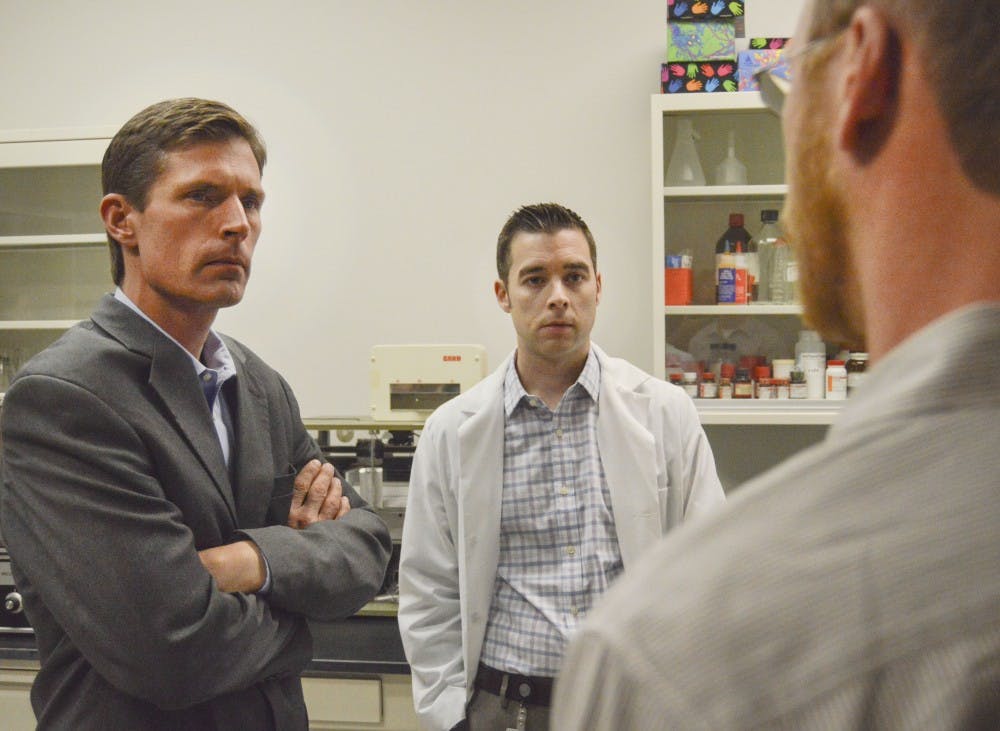 U.S. Sen. Martin Heinrich, left, speaks with Assistant Professors Jonathan Brigman, center, and Jason Weick, right, about an apparatus called a catwalk used to measure gait in animals, in a lab at the Biomedical Research and Integrative NeuroImaging Center at north campus on Monday afternoon. Heinrich came to UNM to discuss health initiatives with members of the Brain and Behavioral Health Institute.