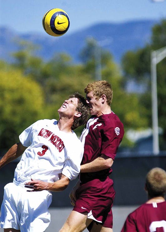 UNM's Andrew Boyens heads the ball in front of College of Charleston's Doug Edwards on Sunday at the UNM Soccer Complex. The Lobos won, 3-2.