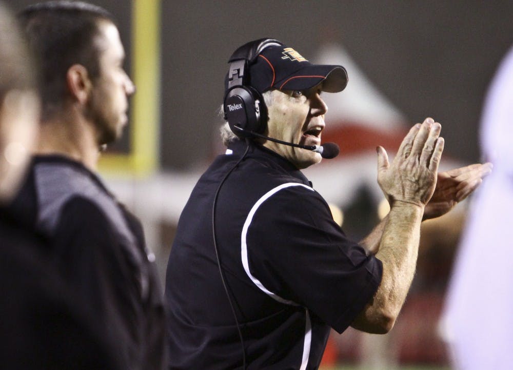 	San Diego State defensive coordinator Rocky Long applauds on the sideline at University Stadium. Long is a former UNM head coach who spent 11 seasons as the face of Lobo football. See back page for full story. 