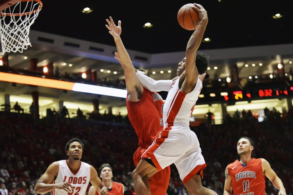 Sophomore guard Elijah Brown leaps through a Rogers State player at WisePies Arena Friday night. The Lobos beat Rogers State 80-69.&nbsp;