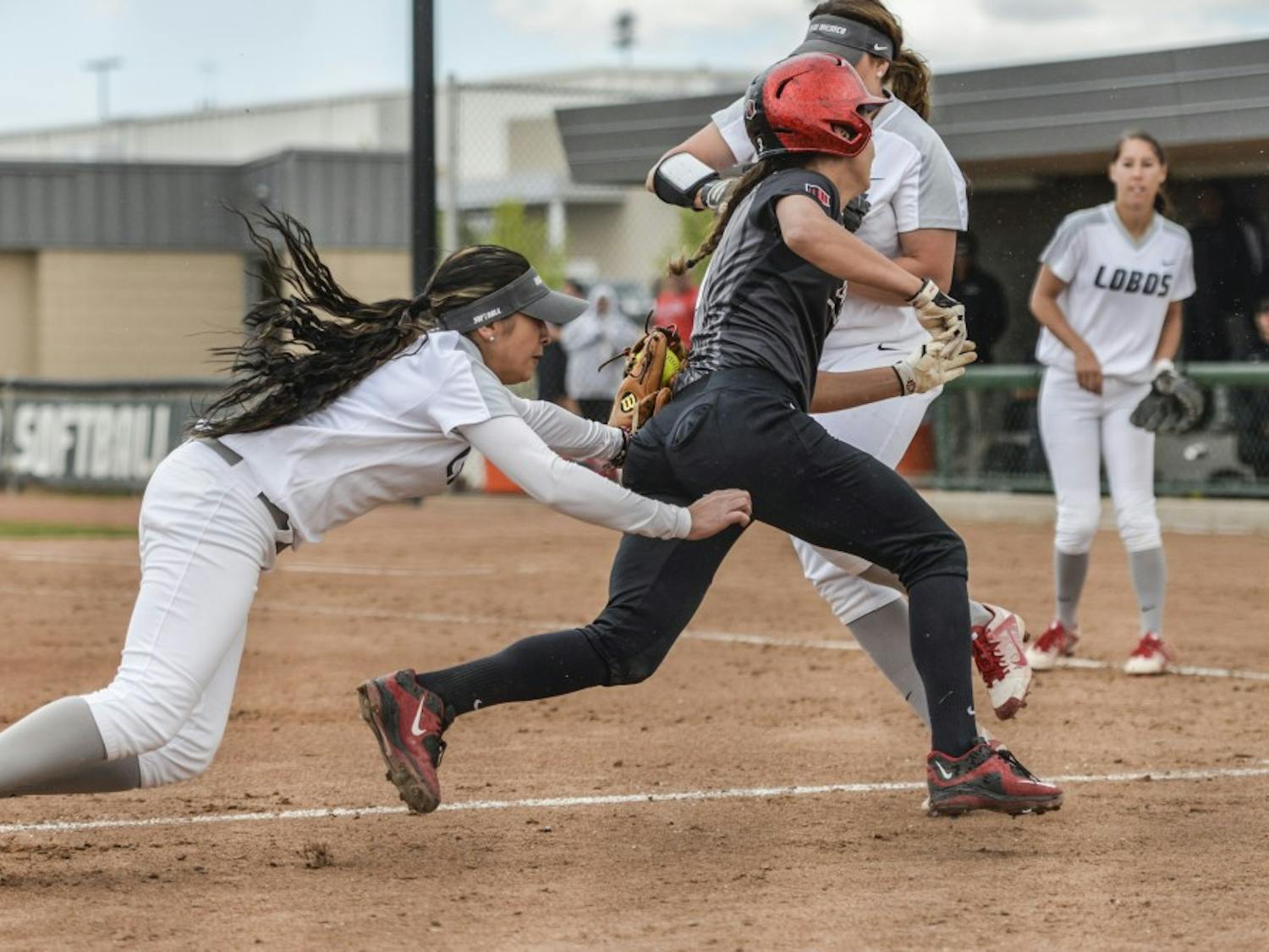 Junior infielder Michala Erickson tags out a San Diego State player Sunday afternoon at the Lobo Softball Fields. The Lobos beat the Aztecs 3-2.&nbsp;