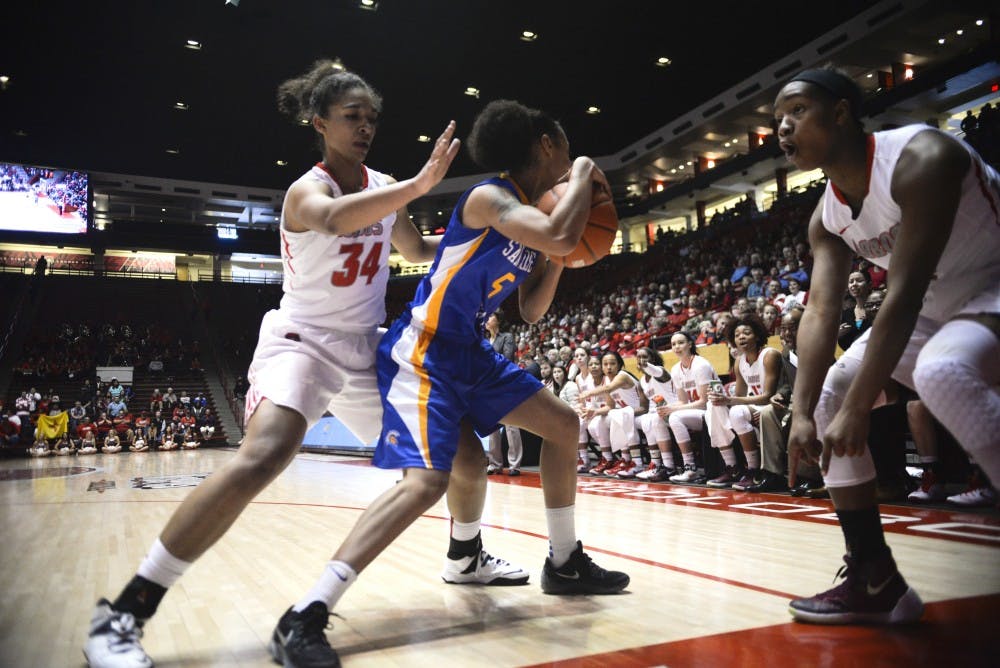 Redshirt junior center Whitney Johnson (34) guards a San Jose State player while guard Alex Lapeyrolerio points to an referee to signify an out of bounds call Saturday afternoon at WisePies Arena. The Lobos beat San Jose State 71-57.