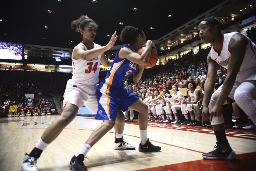 Redshirt junior center Whitney Johnson (34) guards a San Jose State player while guard Alex Lapeyrolerio points to an referee to signify an out of bounds call Saturday afternoon at WisePies Arena. The Lobos beat San Jose State 71-57.
