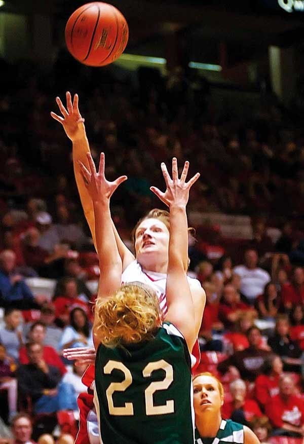UNM guard Amy Beggin shoots over Eastern New Mexico's Stephanie Bailey during Sunday's exhibition game at The Pit. The Lobos defeated the Zias 98-66.