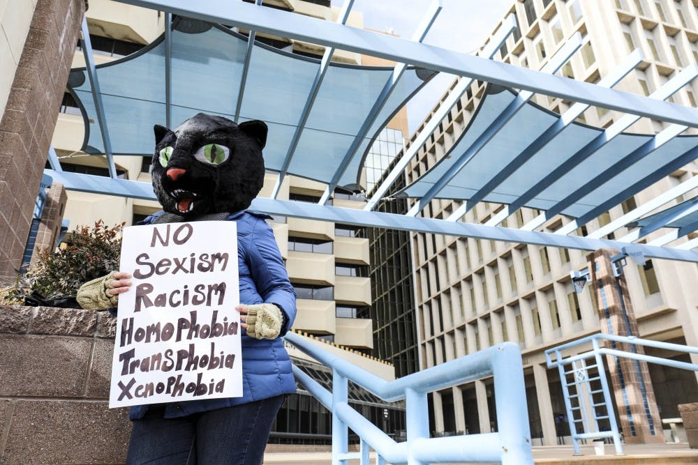 A woman?s rights supporter holds a sign while wearing a cat costume during the women?s march at the Civic Plaza. Hundreds of women, children and men attended the event in support of gender rights and other causes.
