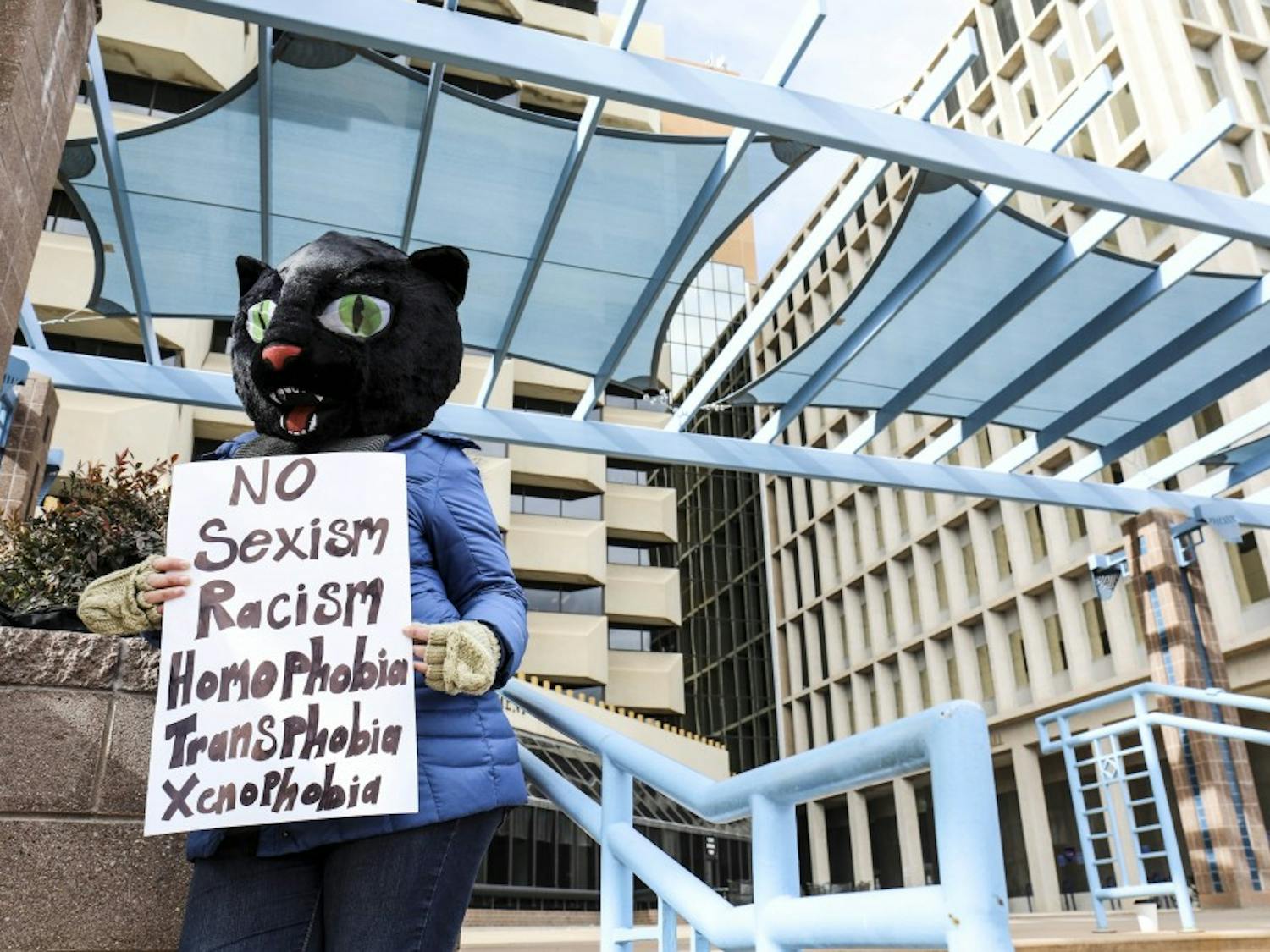 A woman?s rights supporter holds a sign while wearing a cat costume during the women?s march at the Civic Plaza. Hundreds of women, children and men attended the event in support of gender rights and other causes.
