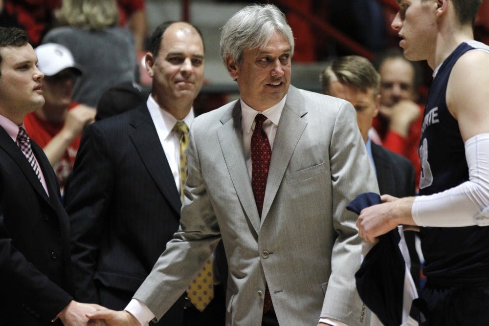 	UNM head coach Craig Neal shakes hands with Utah State graduate assistant Brian Green at the beginning of the game in The Pit. New Mexico defeated Utah State 67-58 to improve to 22-5 overall and 13-2 in the Mountain West.