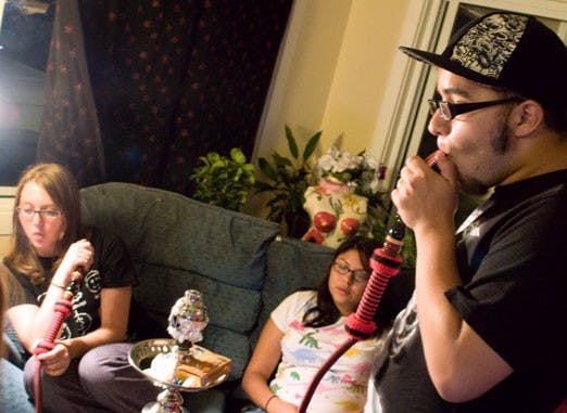 From left: Electra Kennedy, Nizhoni Macias and Gabe Macias gather to smoke hookah Monday. 