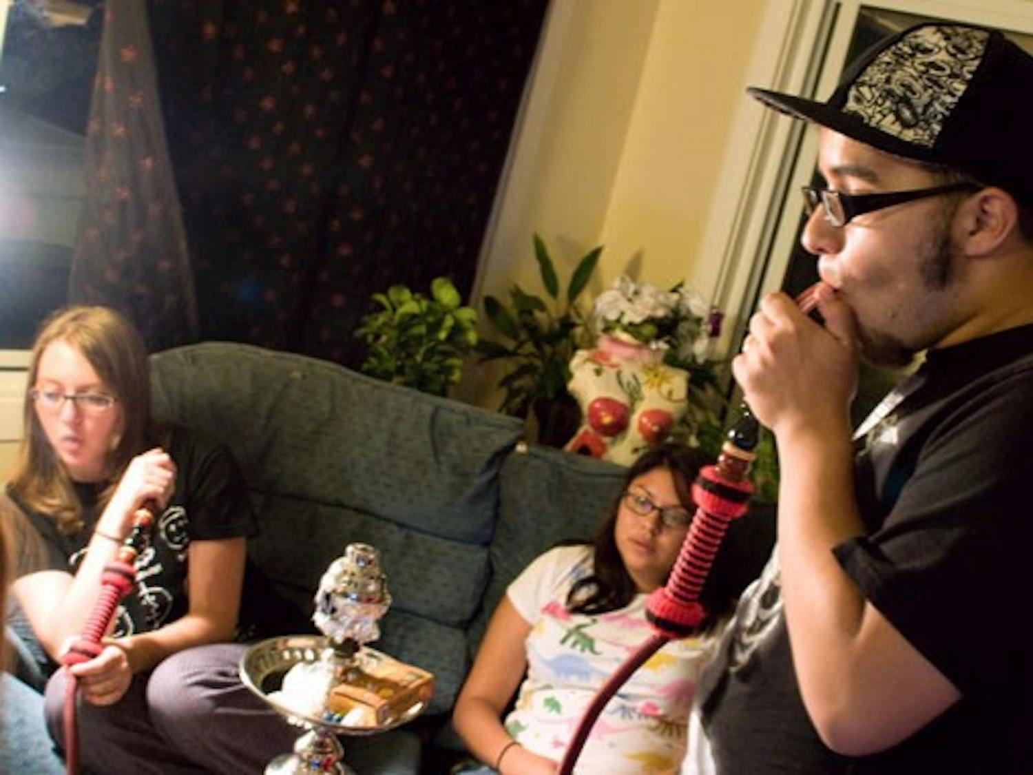 From left: Electra Kennedy, Nizhoni Macias and Gabe Macias gather to smoke hookah Monday.