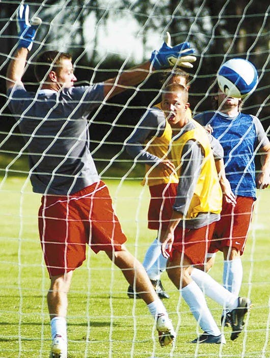 UNM sophomore Jack Smithson, right, watches a header go past goalkeeper Mike Graczyk during a practice at Robertson Field on Wednesday.