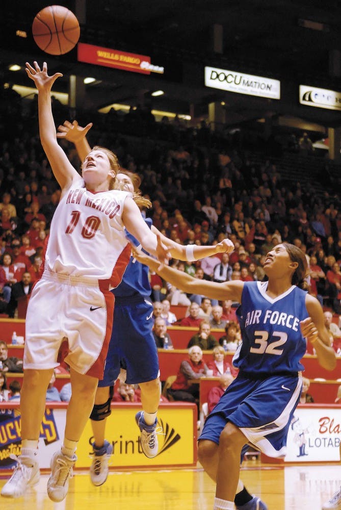 UNM guard Amy Beggin reaches for a rebound after a shot from Air Force forward Alecia Steele in the first half of Thursday's game at The Pit. The Lobos won 60-46 for their first win at home since Dec. 21.