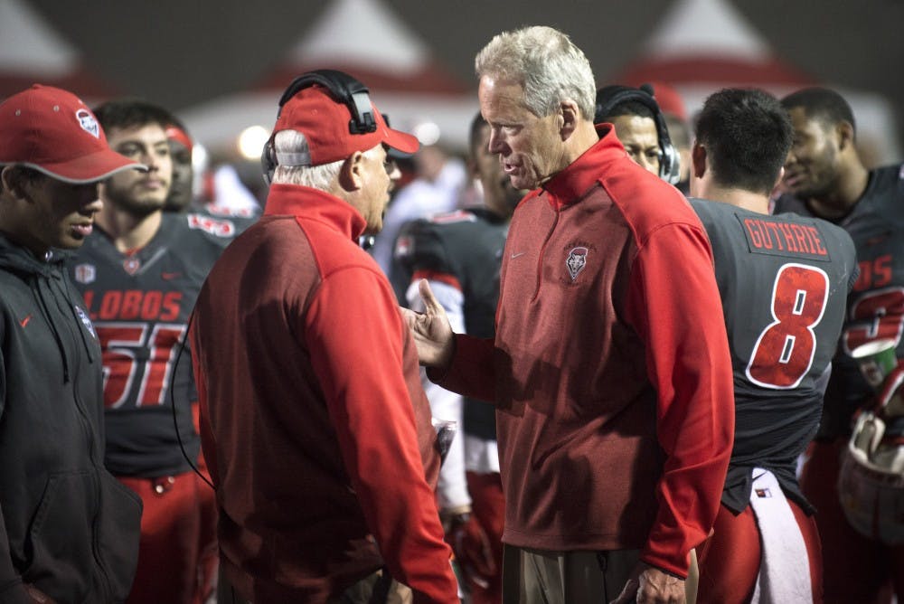 New Mexico head coach Bob Davie, right, speaks with defensive coordinator Kevin Cosgrove during the game against Boise State on Saturday. The Lobos must win its remaining three games in order to be bowl eligible.
