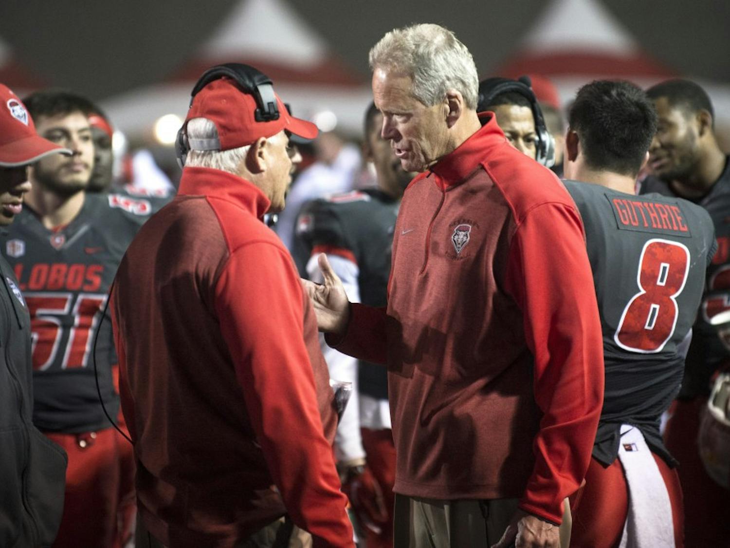 New Mexico head coach Bob Davie, right, speaks with defensive coordinator Kevin Cosgrove during the game against Boise State on Saturday. The Lobos must win its remaining three games in order to be bowl eligible.