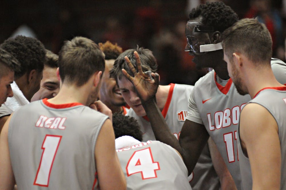New Mexico center Obij Aget (11) gestures the number three to his teammates after the Lobos captured their third win of the season Wednesday night at WisePies Arena. UNM travels to Los Angeles for a road game at Southern California.