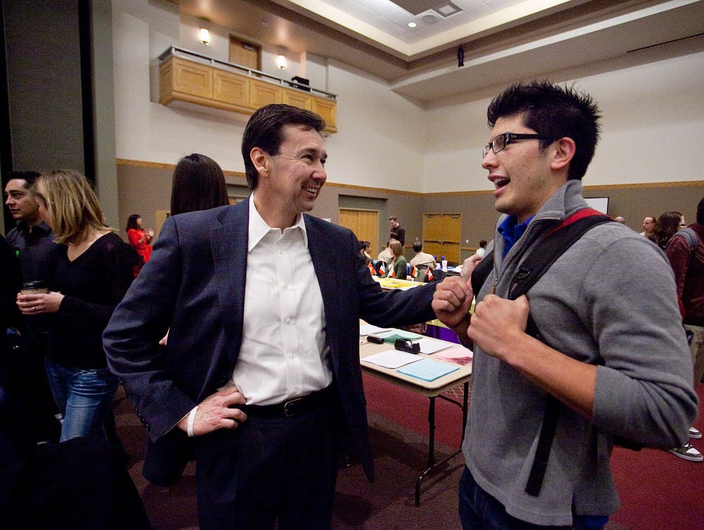 	Political Science major Adam Ornelas laughs with Congressional candidate Jon Barela during the UNM Welcome Back Fair in the SUB Ballroom on Wednesday. The UNM College Republicans invited the candidates to campus to inform students about upcoming New Mexico elections. 