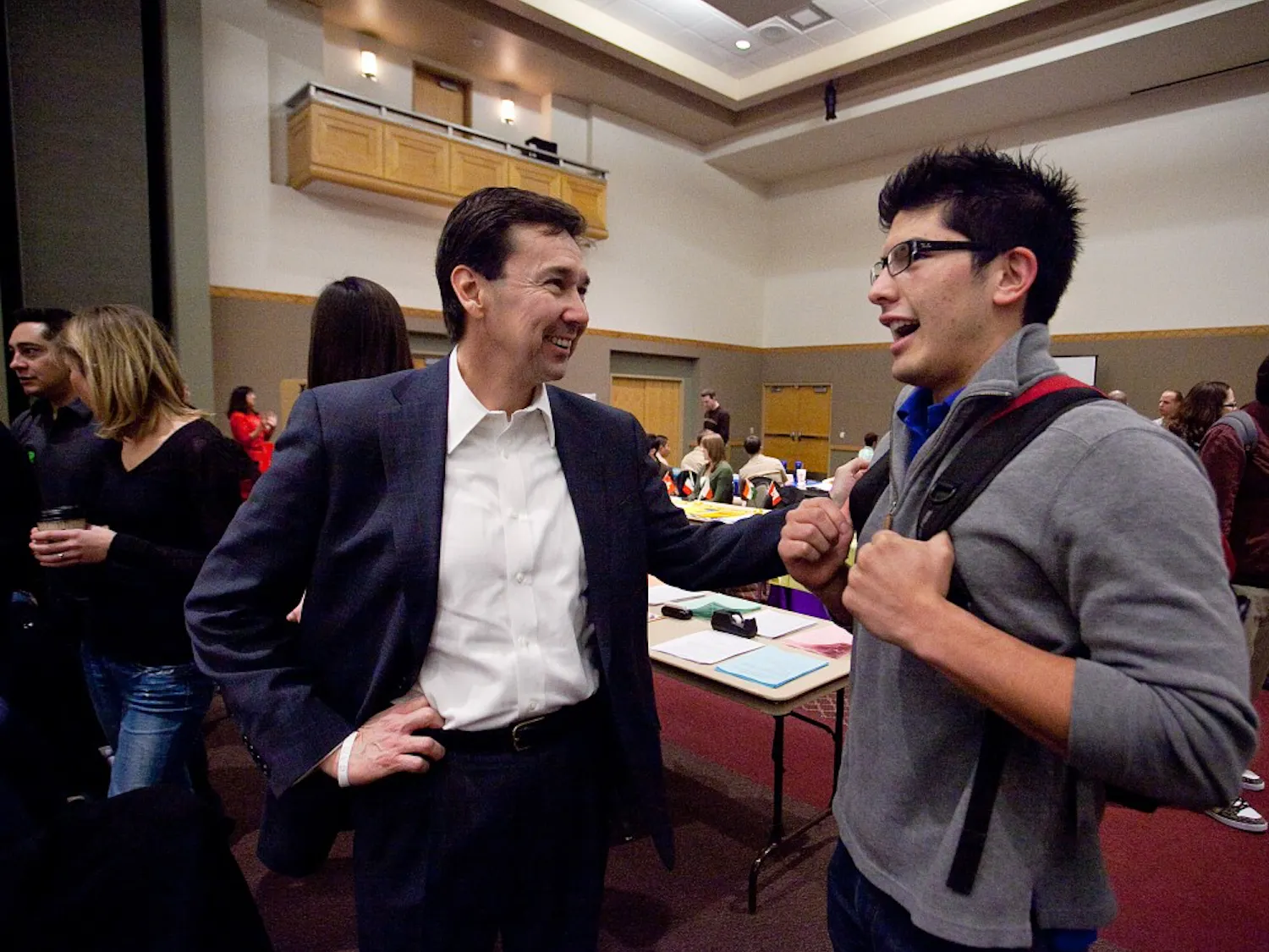 Political Science major Adam Ornelas laughs with Congressional candidate Jon Barela during the UNM Welcome Back Fair in the SUB Ballroom on Wednesday. The UNM College Republicans invited the candidates to campus to inform students about upcoming New Mexico elections.