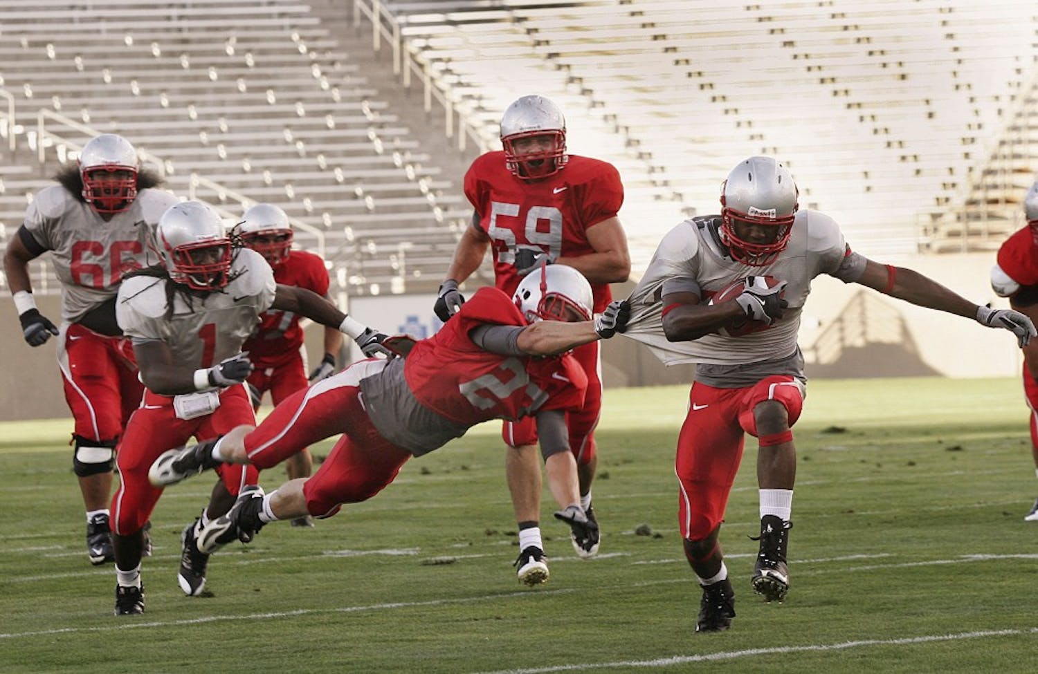 	Safety Jesse Paulsen drags down wide receiver Ty Kirk during a scrimmage at University Stadium in August. The Lobos will look to even their record when they take on Tulsa on Saturday at University Stadium.