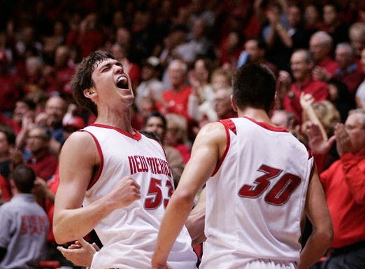 Daniel Faris celebrates with fellow teammate Roman Martinez after UNM blasted BYU 81-62 on Saturday at The Pit.