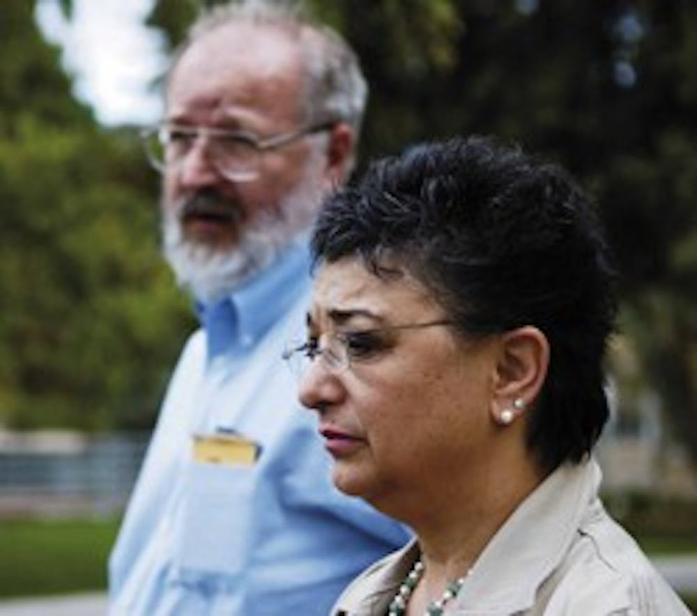 Camila Alire, dean of University Libraries, listens during a news conference in front of Scholes Hall held to update the University community on the status of the Zimmerman Library after Sunday's fire. 