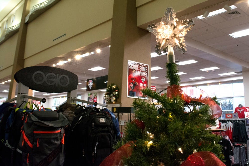 A Christmas tree is decorated with a star and bows at the UNM Bookstore. The bookstore has deals for the holidays on technology, apparel and other school-related items.