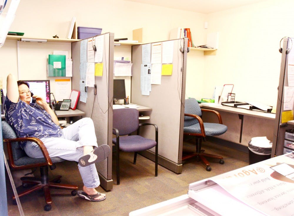 	Brandie Erisman answers a phone call at Agora Crisis Center on August 24. Agora volunteers spend their free time helping those in emotional needs.