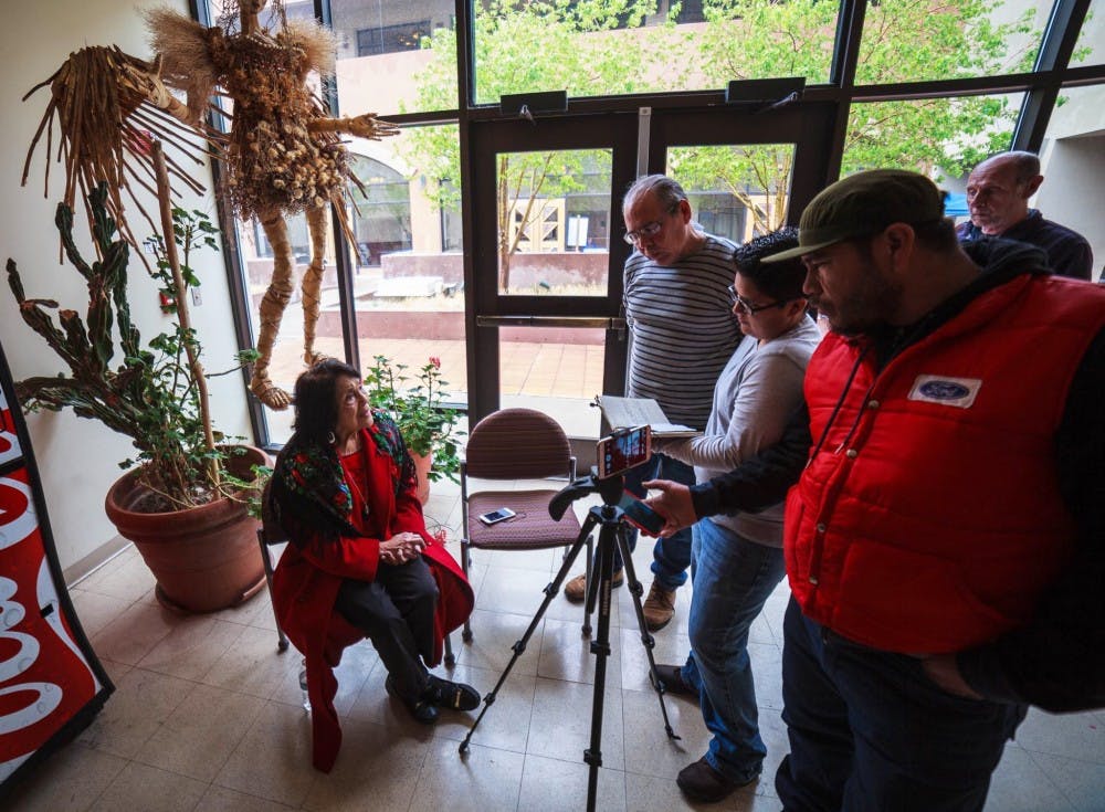 Tu Voz Digital members Manuel Sanz, center, Diana García, center-right, Miguel Andalon, far-right, interview civil rights activist Dolores Huerta. Tu Voz Digital is a group of community journalists that work only using their smartphones to report their stories.