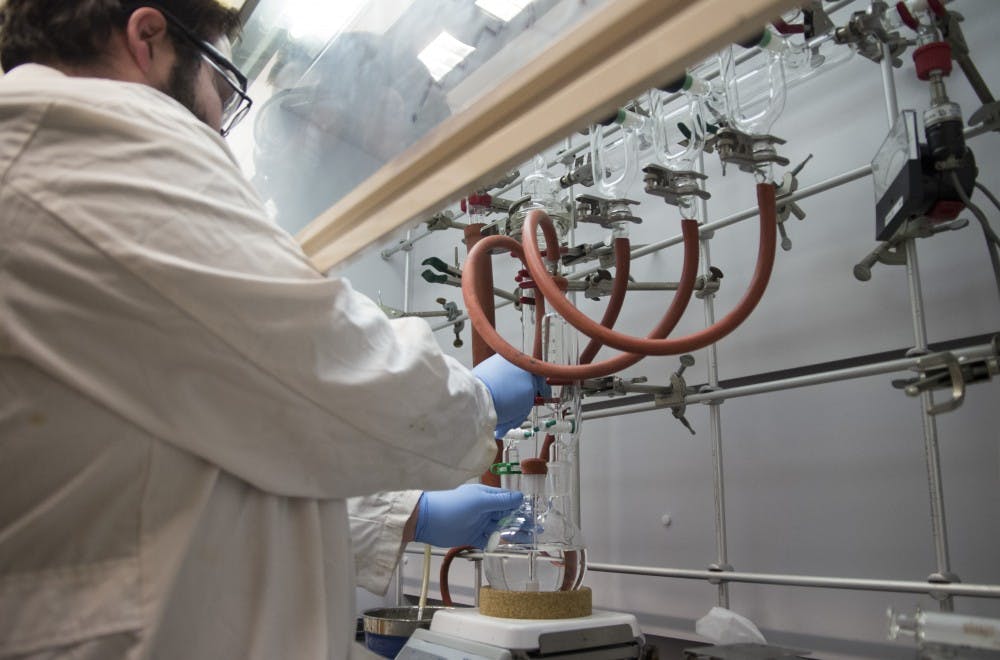 David Santisteven sets up a lab rig on Monday used to create cells that could be used to regenerate heart valves. Santisteven is a biology graduate but the lab consists of a diverse group of researchers. 