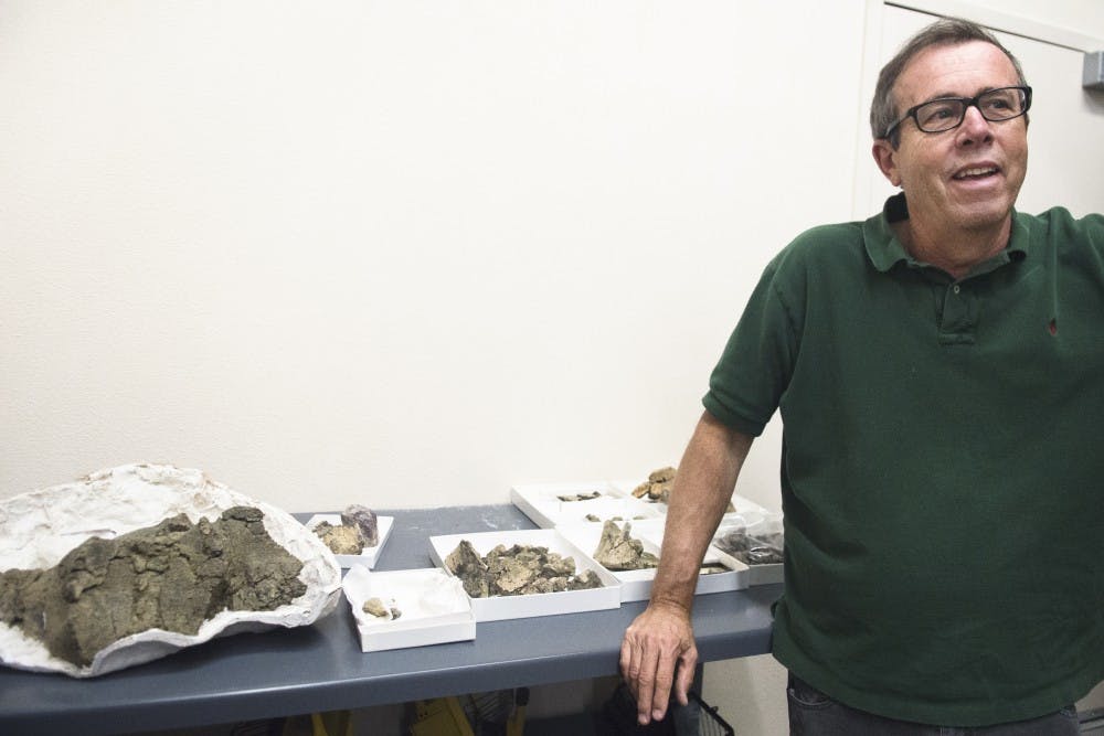 Spencer G. Lucas shows the remains of Ziapeltasanjuanensis, a new dinosaur species that is unique to New Mexico, on Monday at the New Mexico Museum of Natural History and Science. The Ziapelta fossils were found in the Kirtland formation at Hunter Wash, an area in the San Juan Basin located in northeastern New Mexico.