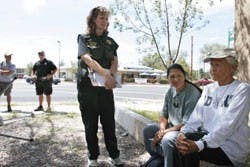 Albuquerque Police Department outreach officer Liz Thompson, center, talks with a former homeless woman who goes by "Mom," right, and Downtown Action Team worker "Sunshine" near Robinson Park on Sunday. The outreach program aids homeless people with food,