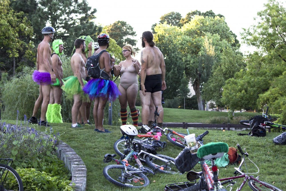 	Bike riders gather in front of UNM’s Duck Pond on Friday afternoon for the (Nearly) Naked Bike Ride. The event began after an initiative was started by Lee Ann Ratzlaff to help promote sharing the road with vehicles and raise awareness for the safety of bike riders around the city. This event is body-positive and is Bikeburque’s first event of the Autumn Pedalfest. 