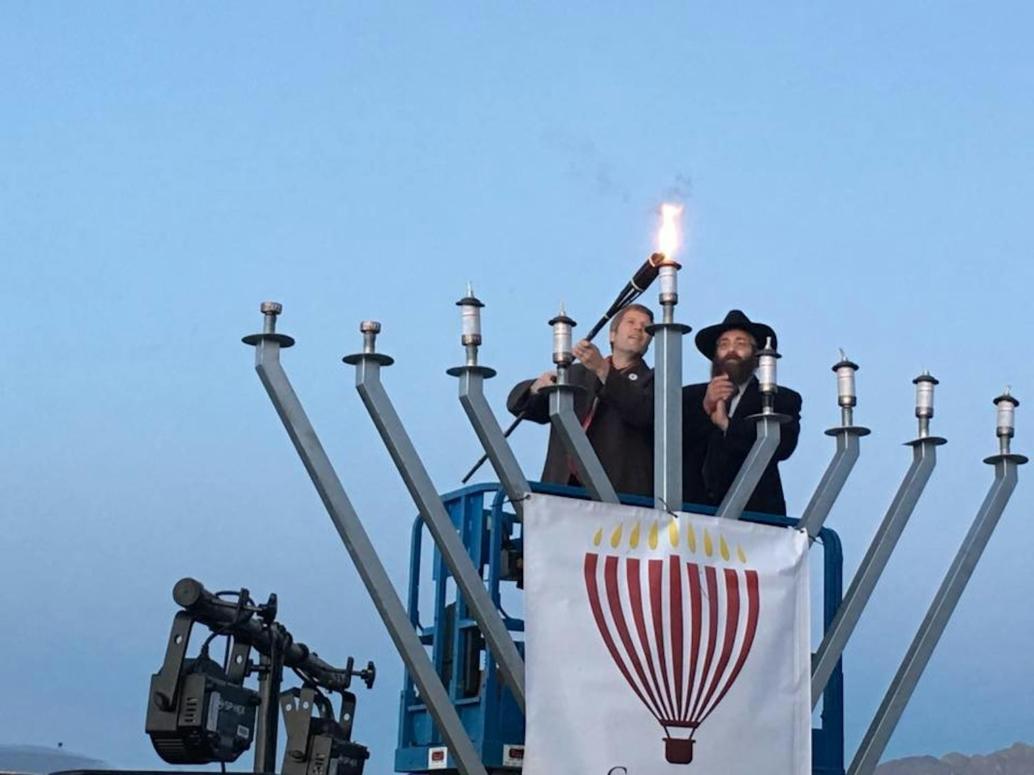 Mayor Tim Keller, left,&nbsp;lights a menorah&nbsp;with Rabbi Schmukler&nbsp;at Balloon Fiesta&nbsp;Park.