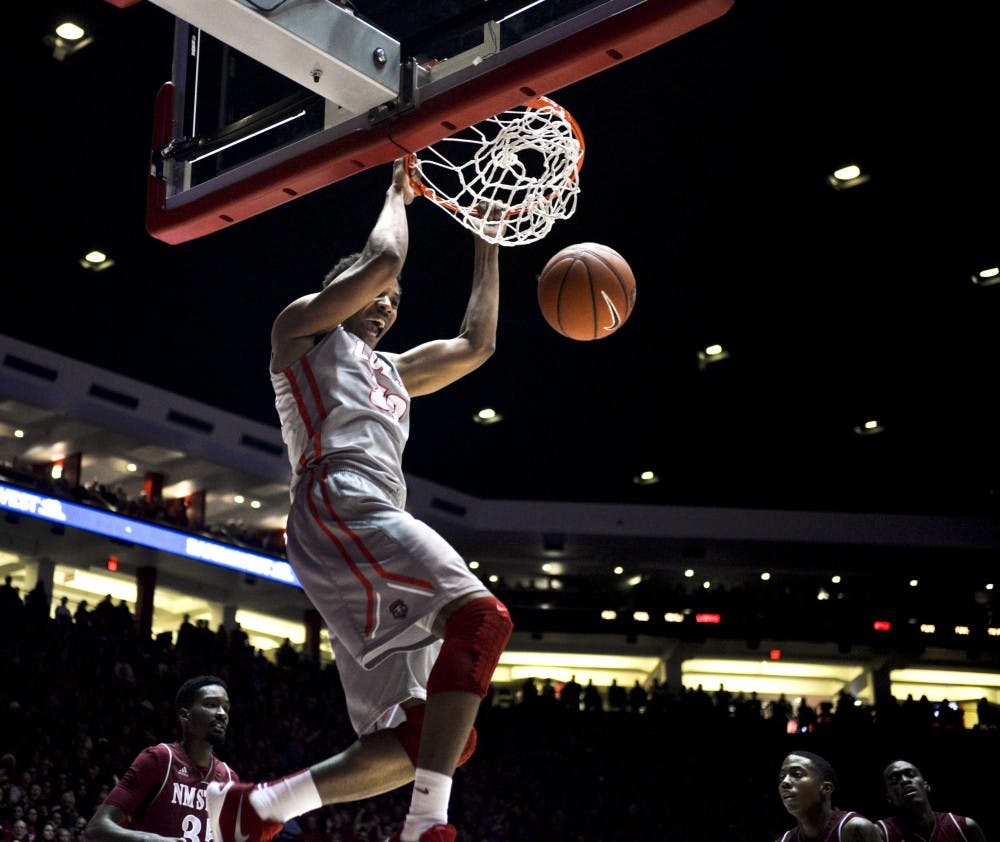 Redshirt junior forward Tim Williams, hangs on to a dunk at WisePies Arena Wednesday night. The Lobos beat NMSU 79-61 and will play Rice this Saturday.&nbsp;&nbsp;