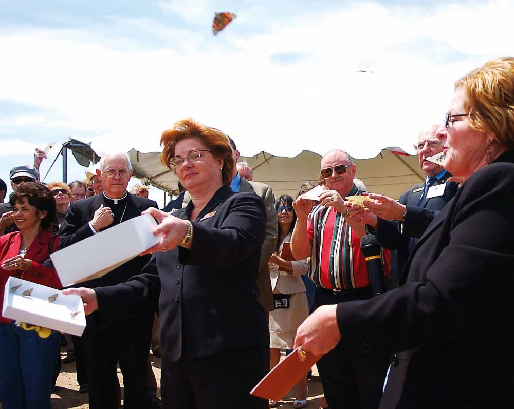 Dr. Cheryl Willman, left, and Linda Karr release butterflies to conclude the groundbreaking ceremony for UNM Cancer Research and Treatment Center on May 15.