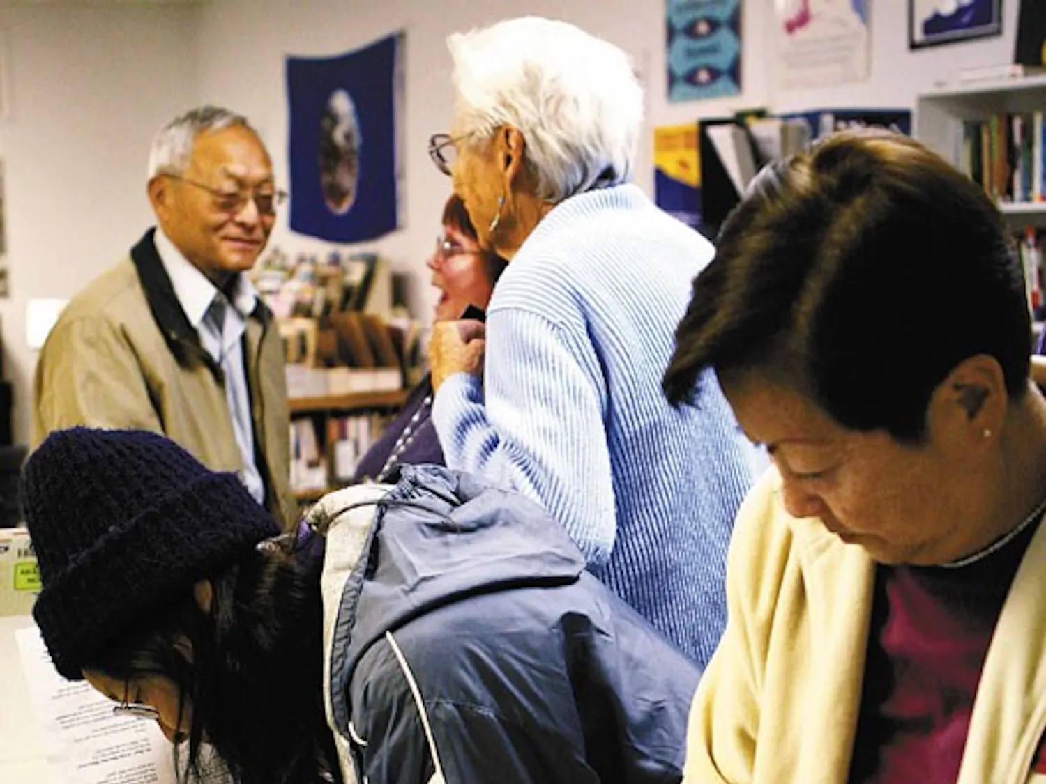 Bob Watada, left, speaks with an audience member at the Albuquerque Center for Peace and Justice on Friday. Watada and his wife, Rosa Sakanishi, right, are on a 16-state tour to raise support for their son, Ehren Watada, who is the first commissioned offi