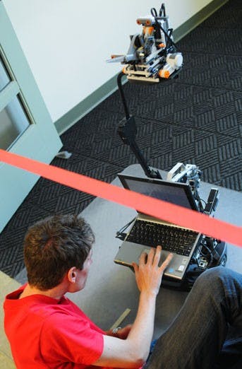 Student Nicola Bezzo works on a robot named Figaro before the ribbon-cutting ceremony at Centennial Engineering Center on Sunday.  
