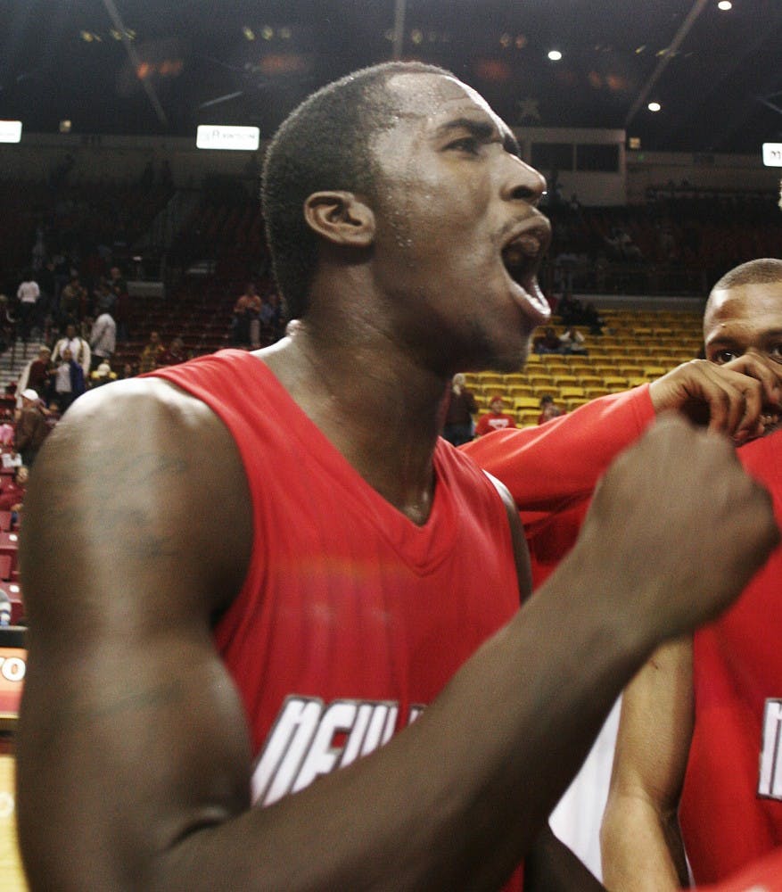 	Forward Will Brown pumps his fist in exaltation after the Lobos squeezed by NMSU, 97-87, at the Pan American Center in Las Cruces Tuesday.