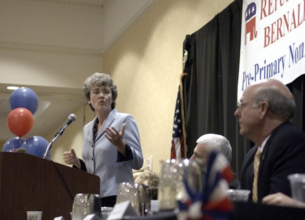Rep. Steve Pearce, right, listens to Rep. Heather Wilson speak during the Bernalillo County Pre-Primary Convention on Sunday. Wilson and Pearce are vying for the Senate seat being vacated by Sen. Pete Domenici. 