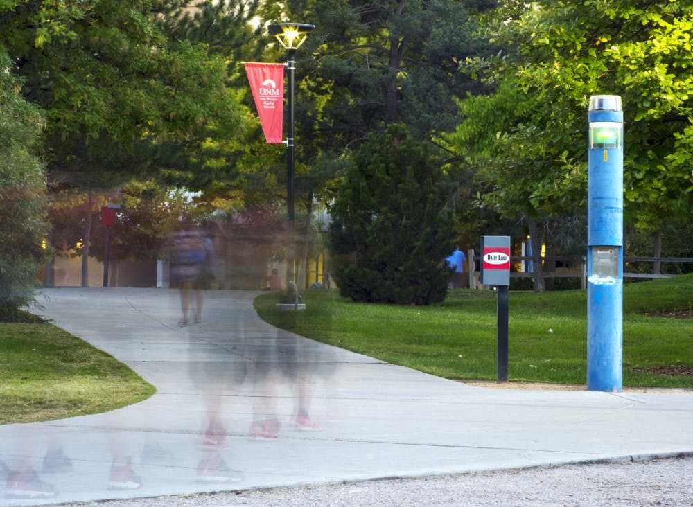 One of UNM’s blue emergency pillars stands as students commute across campus Tuesday. The pillars populate UNM campus, which is one of the top 25 safest universities in the United States.