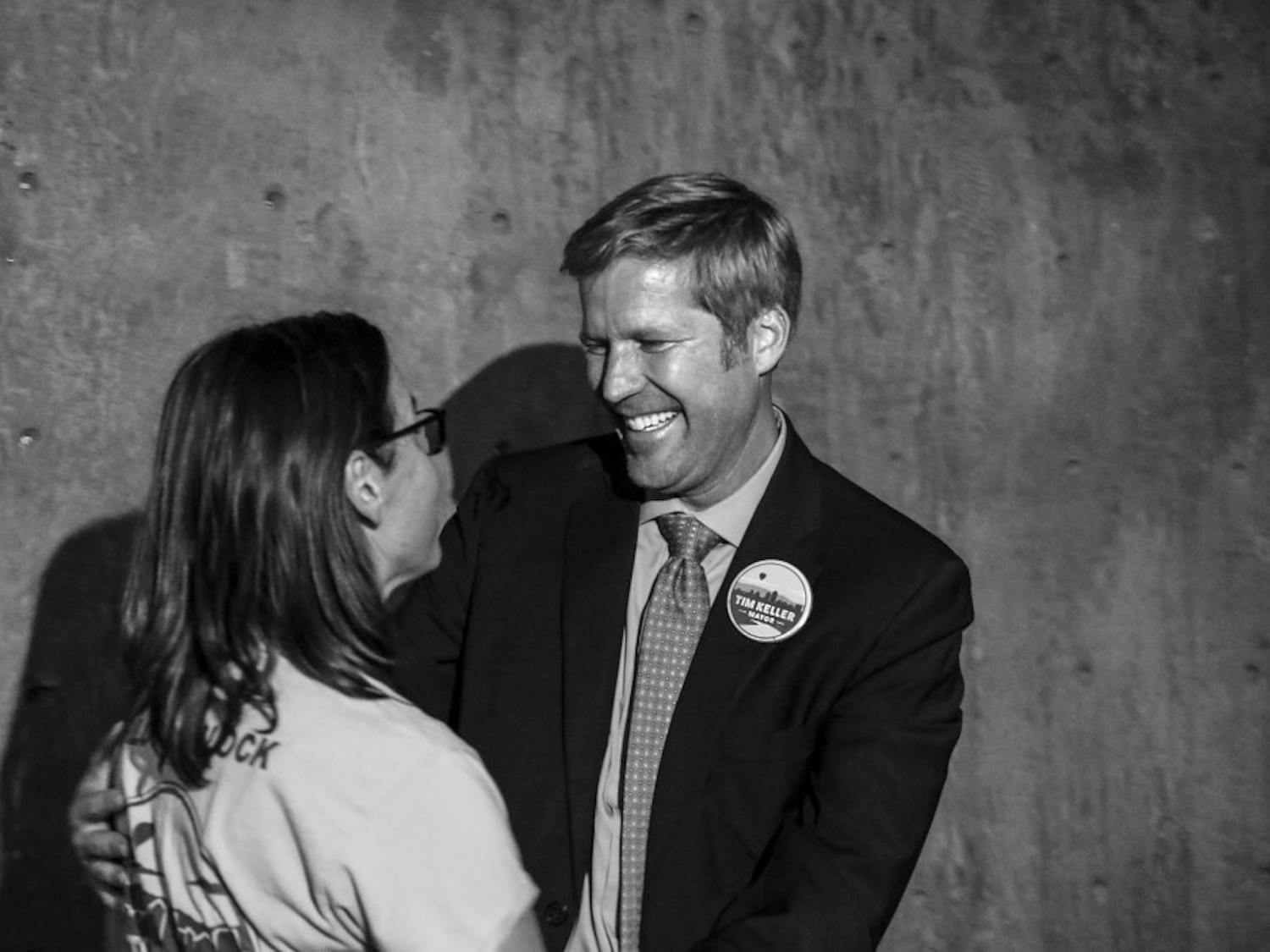 Tim Keller, right, embraces his wife, Liz Kistin Keller on Oct. 03, 2017 during the mayoral watch party at Red Door Brewing Company. 
