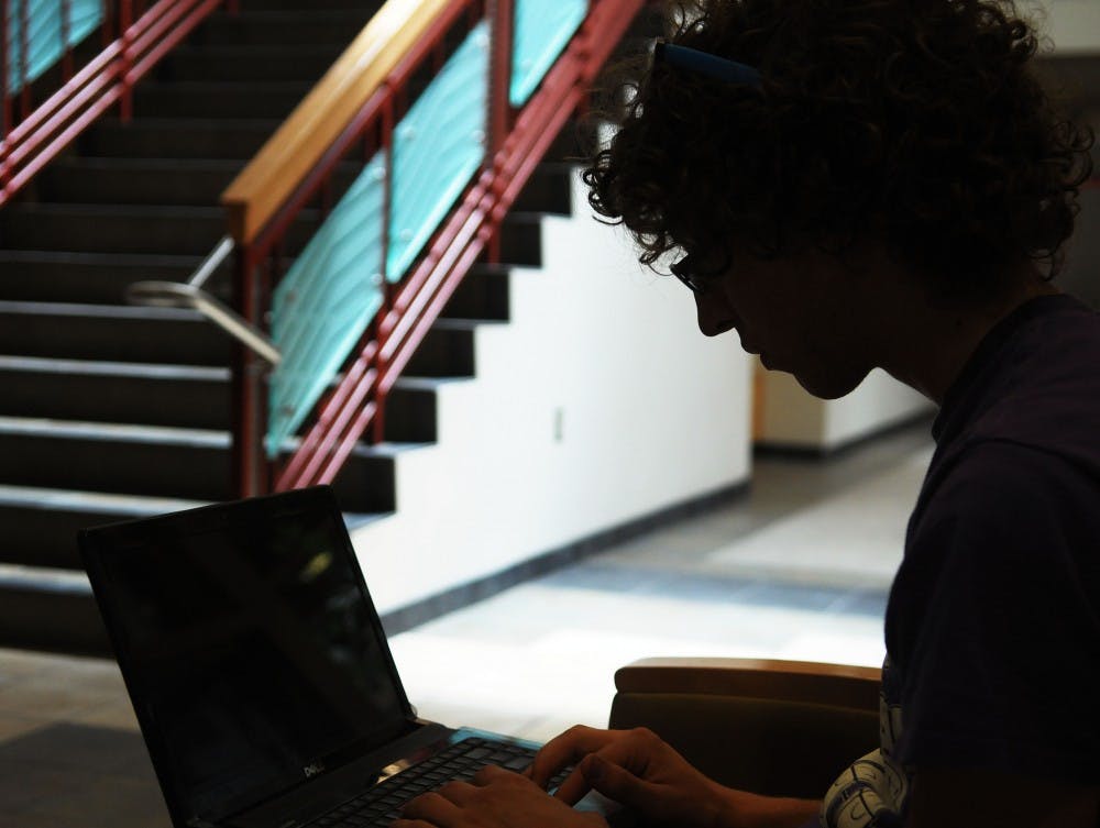 	Alex Borowski edits tunes on his laptop in the SUB on June 4. Borowski is one of the two members of Cobra Moonshine, a band that creates mashup songs available for free download.
