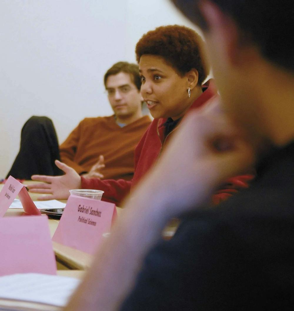 Christopher Ramirez, left, listens to Michelle Touson talk during a roundtable discussion about first-generation minority graduate students Tuesday in the SUB. 